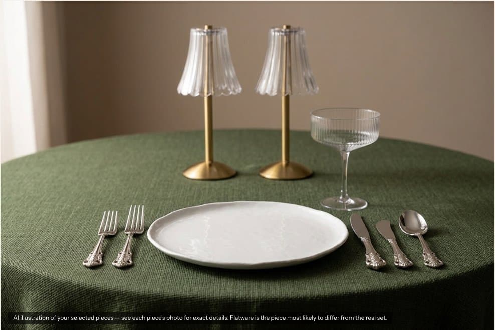 AI illustration of a place setting: olive green linen, white plate, ornate silver flatware, a ribbed coupe glass and two gold cordless lamps with fluted glass shades